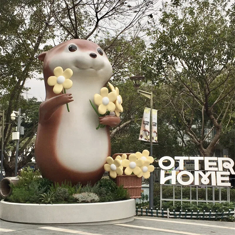 Cartoon Flower-Holding Otter Fiberglass Sculpture | Outdoor Plaza IP Decor Statue | Custom Cute Otter Ornament