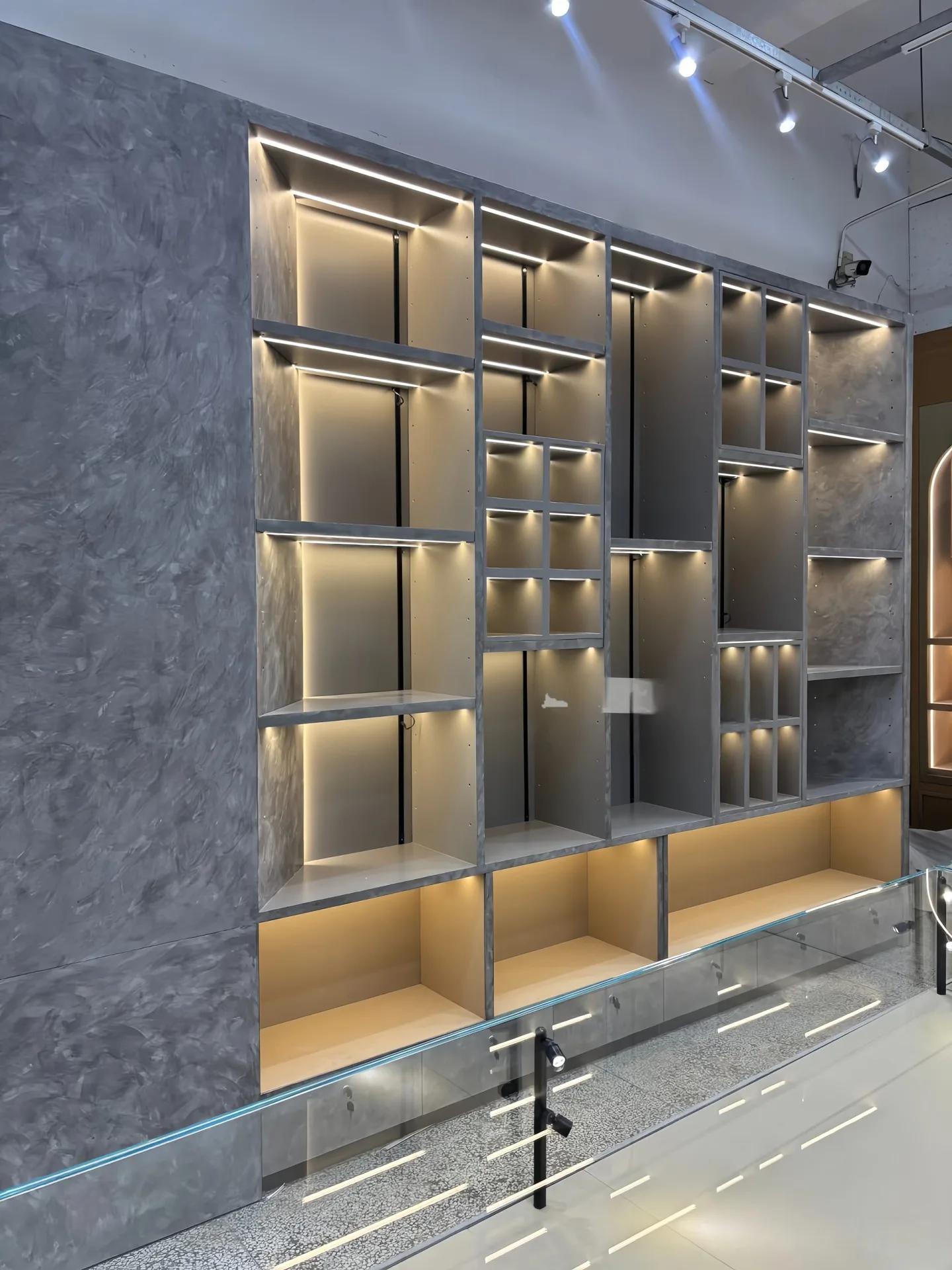Custom Geometric Wall Display Unit with Hidden LED Lighting & Marble-Texture Backing — view 5