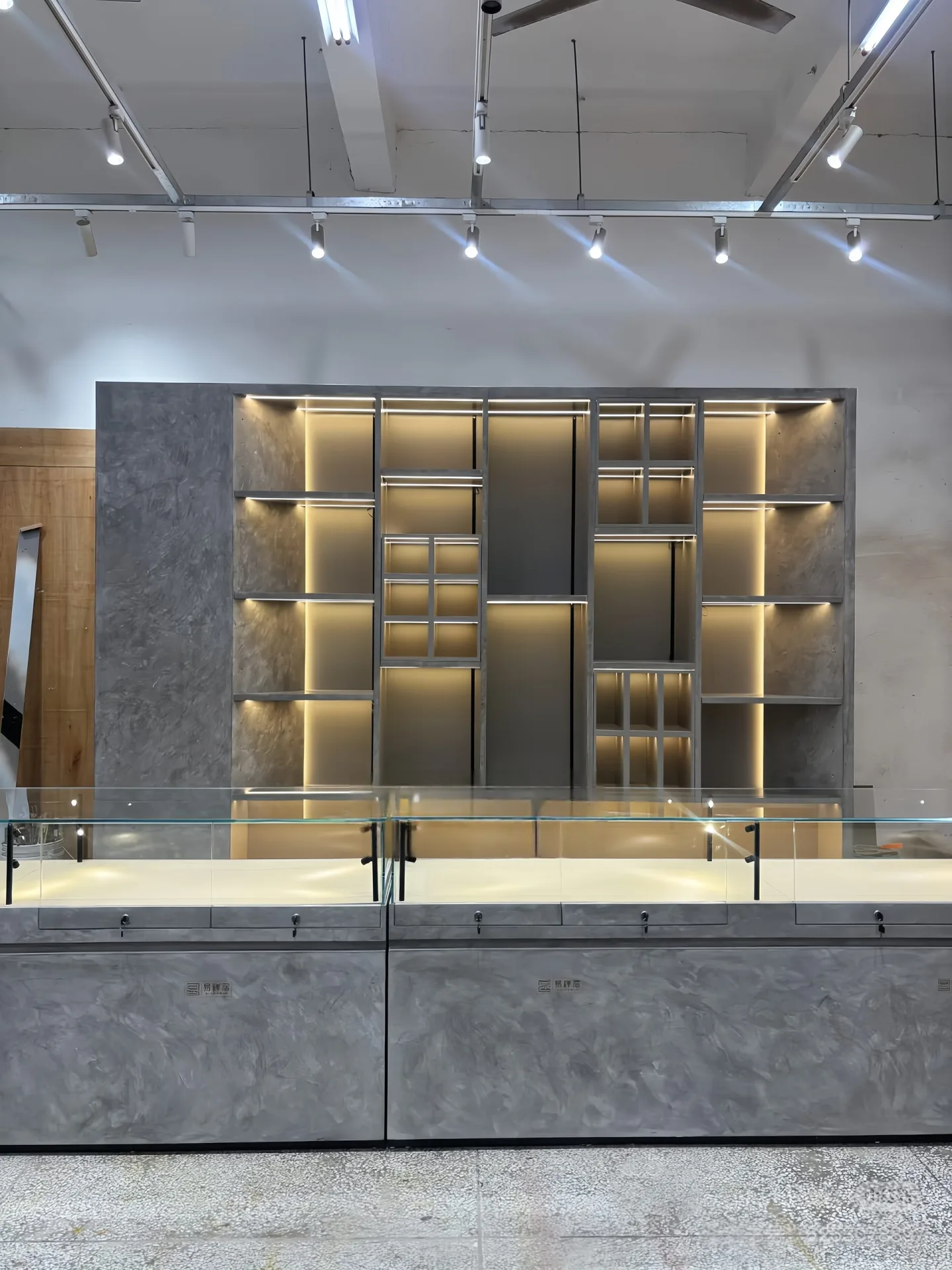 Custom Geometric Wall Display Unit with Hidden LED Lighting & Marble-Texture Backing — view 4