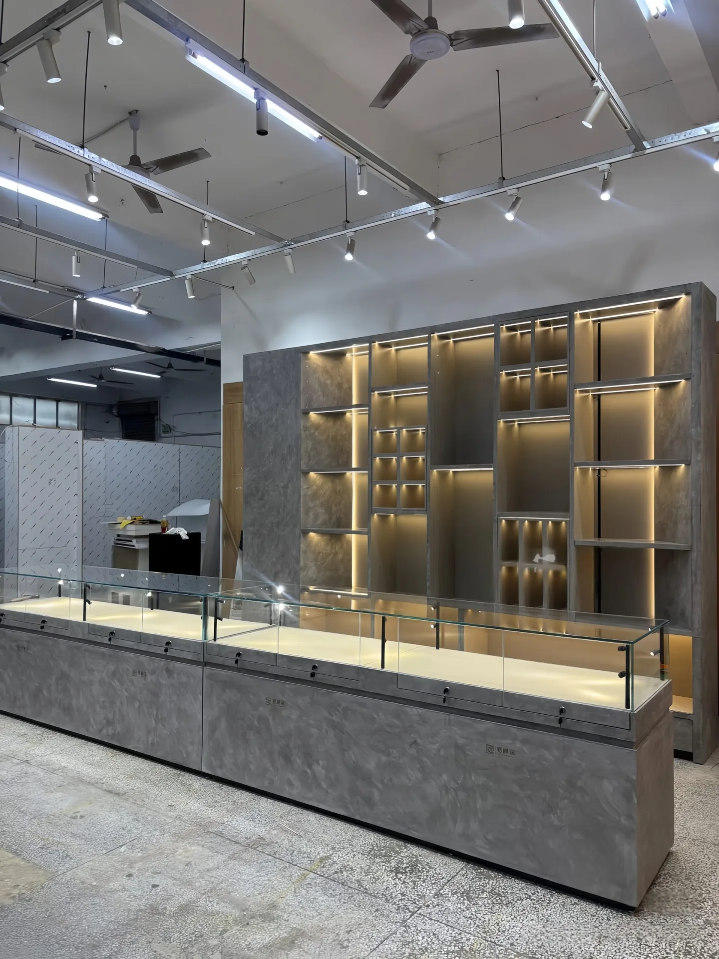 Custom Geometric Wall Display Unit with Hidden LED Lighting & Marble-Texture Backing — view 3