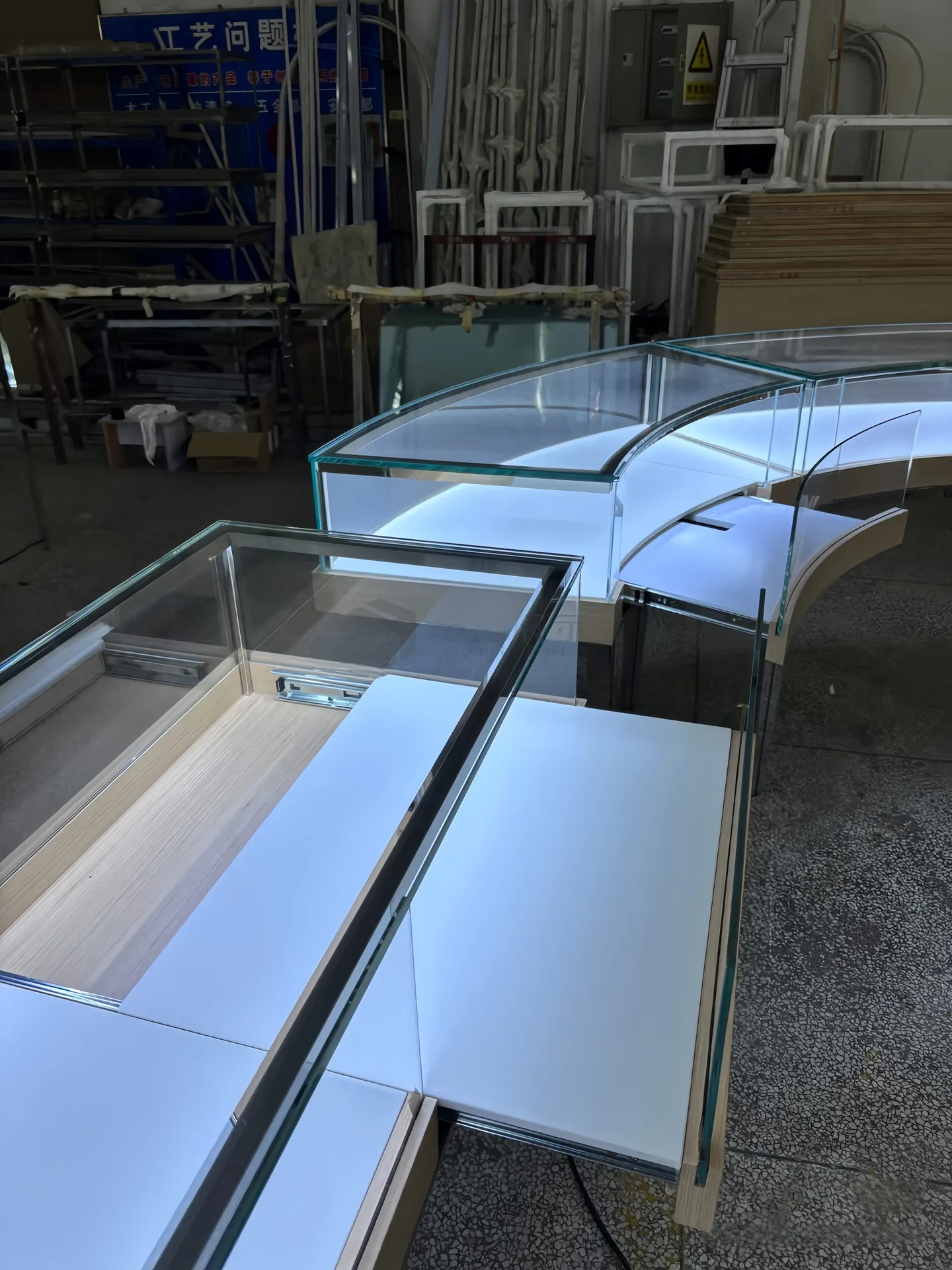 Modular Curved Glass Jewelry Display Counter | S-Shaped Retail Island with Metal Legs & White Top — view 3