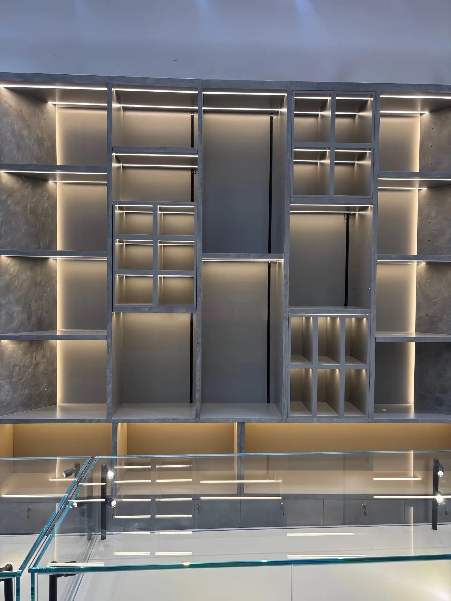 Custom Geometric Wall Display Unit with Hidden LED Lighting & Marble-Texture Backing