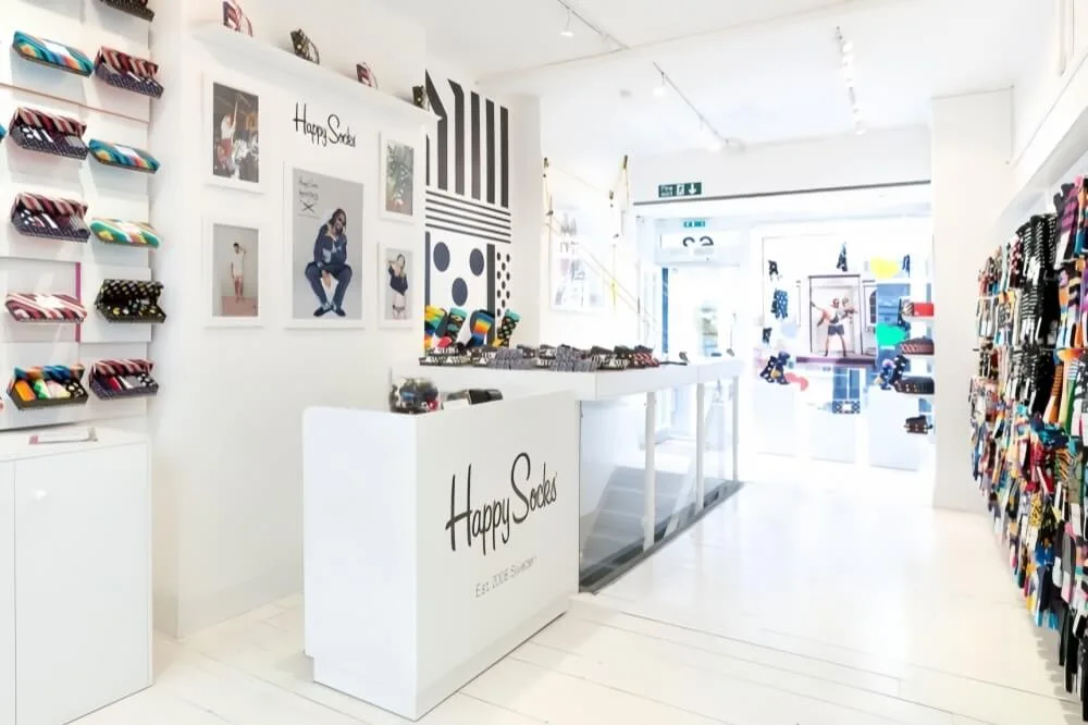 Socks Shop Design, Displays Rack Fixtures – Modern Socks Shop Design with White Wall Cabinets and High-end Display Stands ima